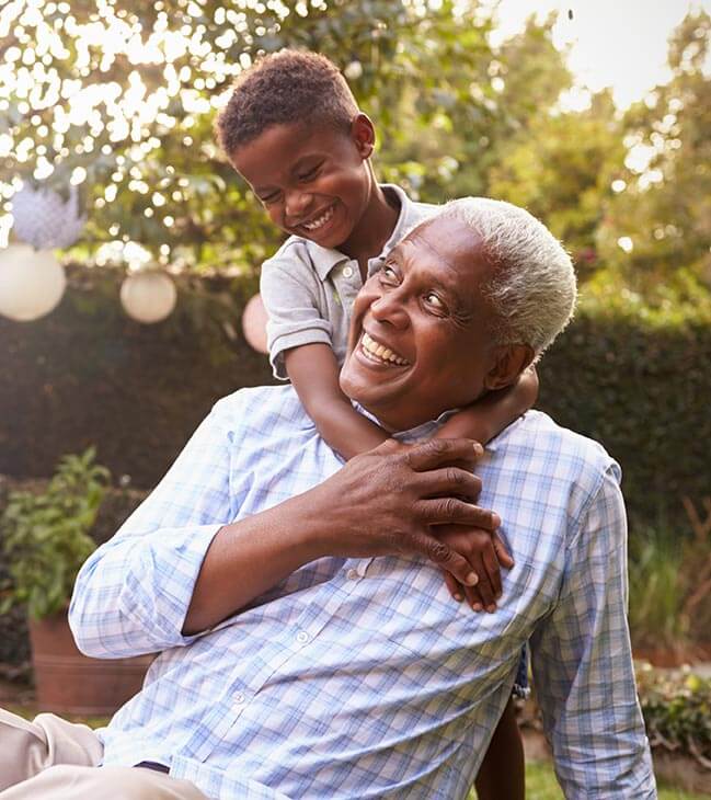 Older man and young child having fun outside