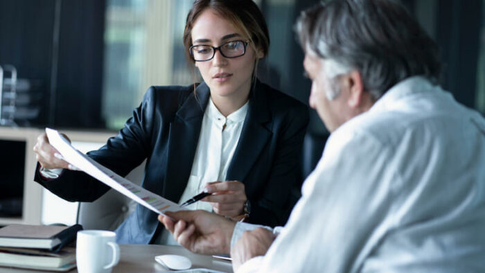 Woman reviewing paperwork with patient