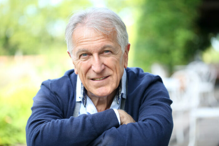 Older man with arms crossed